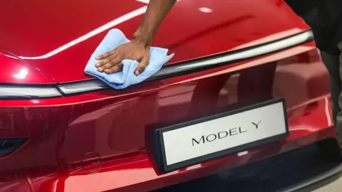 Bloomberg/Getty A worker cleans a Tesla Model Y electric vehicle at the newly opened Tesla Inc. store at Bandra Kurla Complex (BKC) in Mumbai, India, on Tuesday, July 15, 2025. 