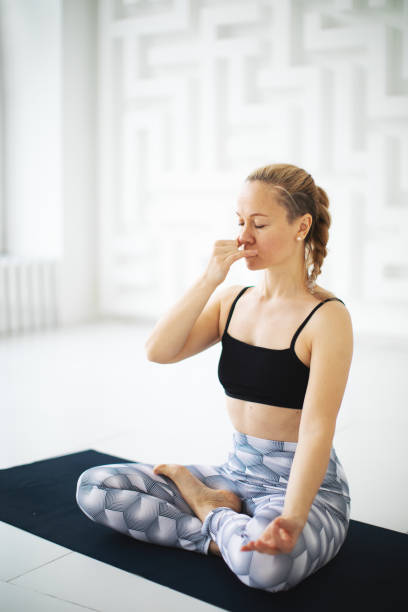 Alternate Nostril Breathing: Sit comfortably with your spine straight. Use your right thumb to close your right nostril. Now inhale deeply through your left nostril. Continue by closing your left nostril with your right ring finger and releasing your right nostril. Inhale and exhale through your right nostril. Repeat this exercise for several cycles.